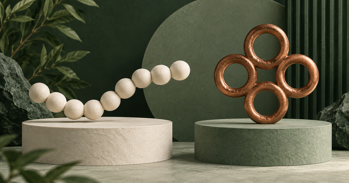 An ivory bead chain and a copper ring sculpture on separate platforms.